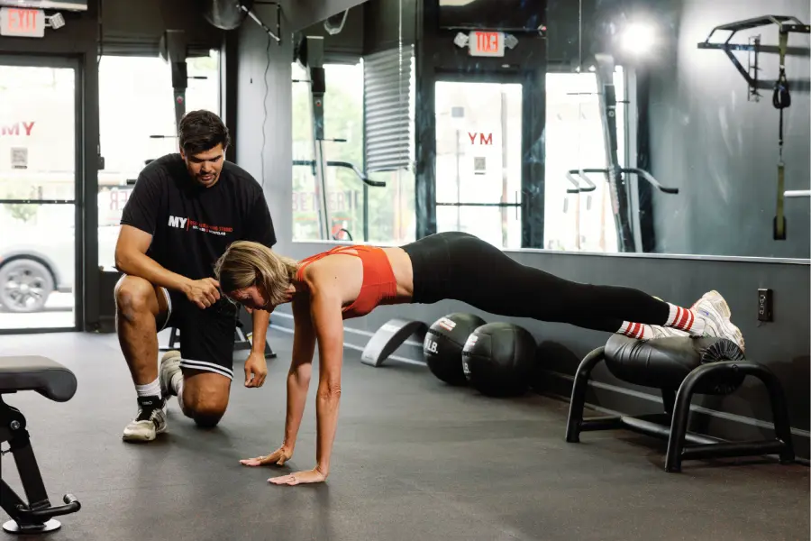 Personal trainer coaching a client during a workout at MY Studio